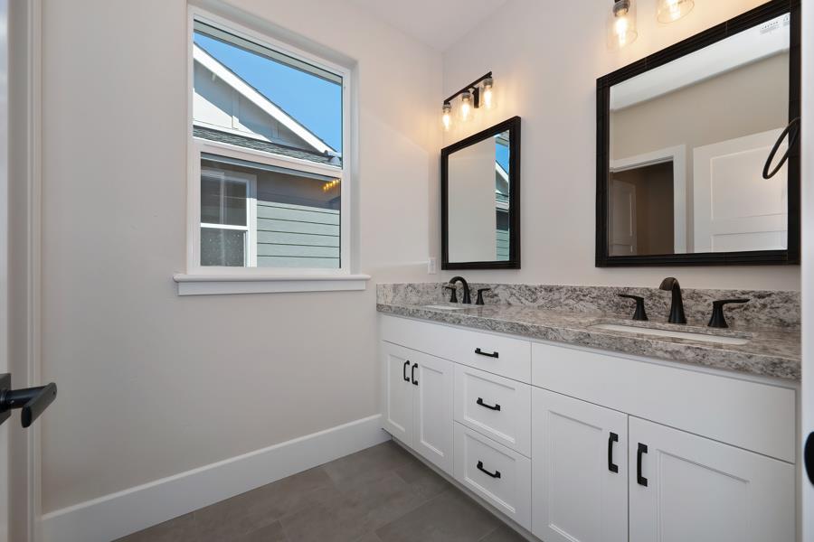 3301 Stone Field Way Loomis, CA 95650 - Photo 30 of 33 a bathroom with double sink and a mirror