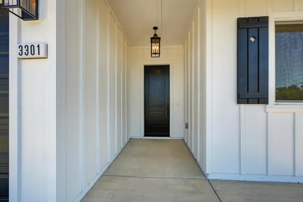 a view of a hallway with wooden cabinets