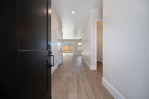 a view of a hallway with wooden floor