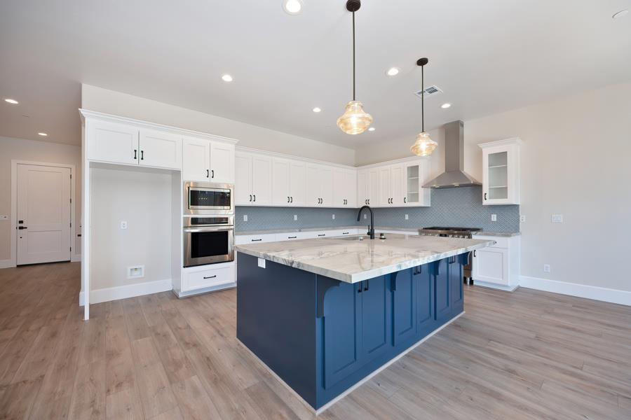 3301 Stone Field Way Loomis, CA 95650 - Photo 6 of 33 a kitchen with kitchen island granite countertop a sink and a stove
