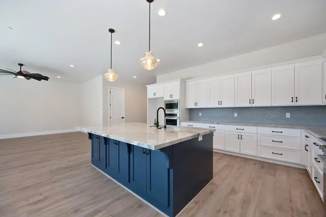 a kitchen with a sink window and cabinets