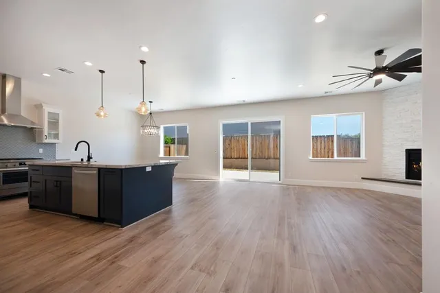 a view of kitchen with sink and wooden floor