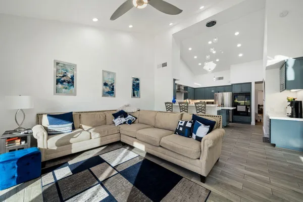 a living room with furniture and wooden floor