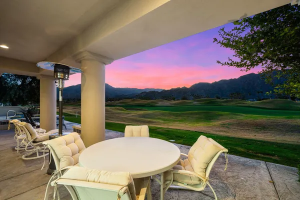 a view of a patio with swimming pool table and chairs