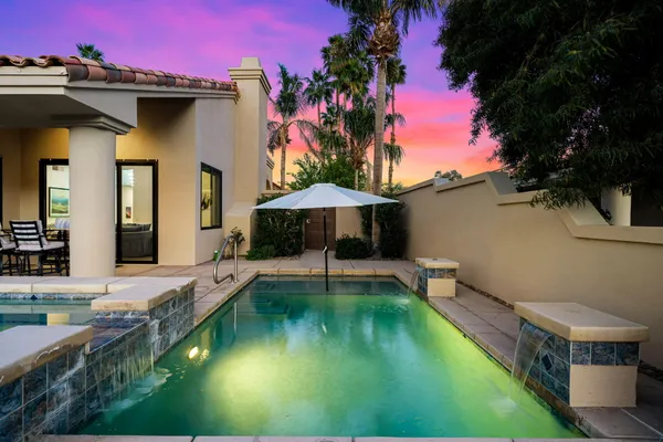 a swimming pool with outdoor seating and yard