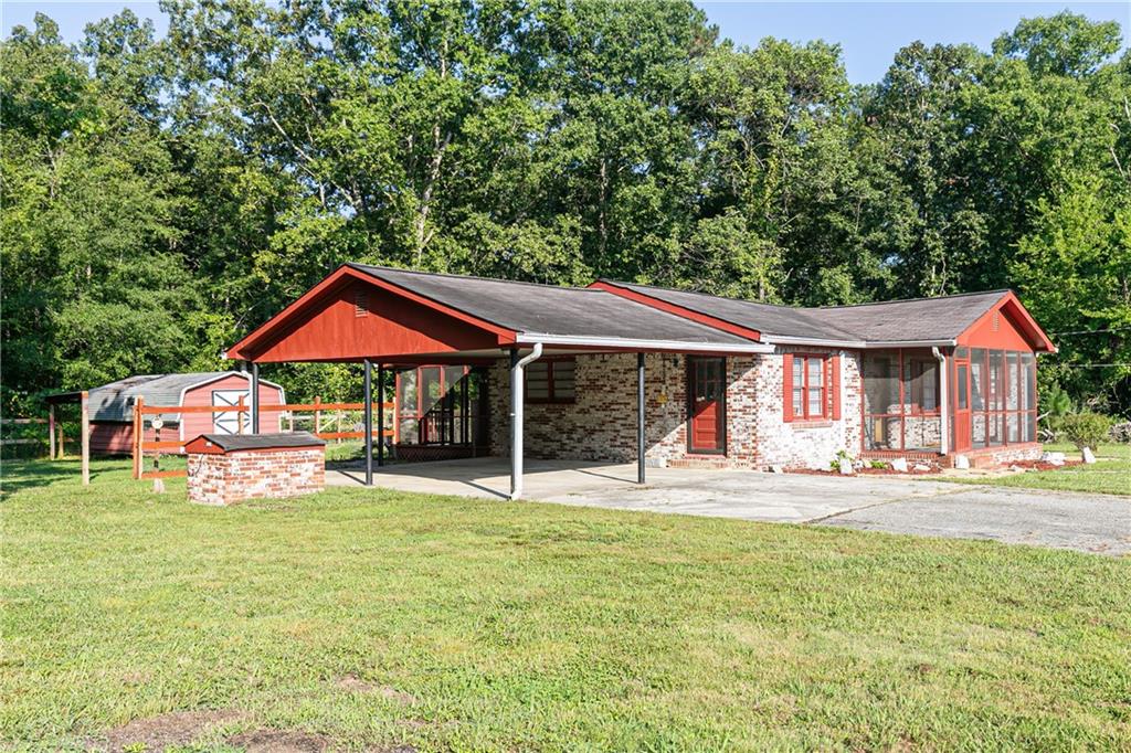 a front view of a house with a yard patio and a garden