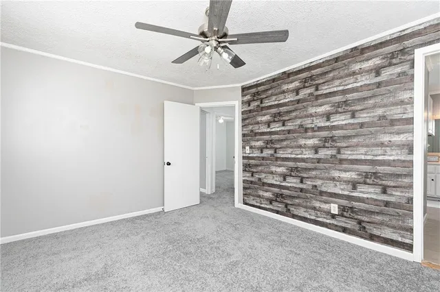 a view of an empty room with a ceiling fan