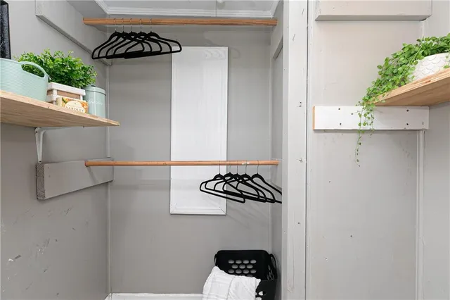 an empty room with a window and ceiling fan