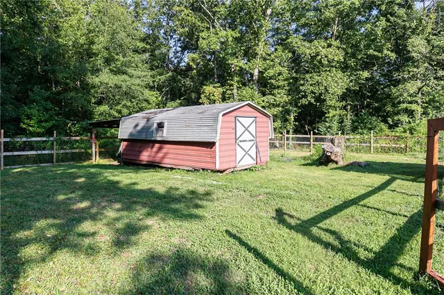 a view of a wooden deck and a yard with swimming pool