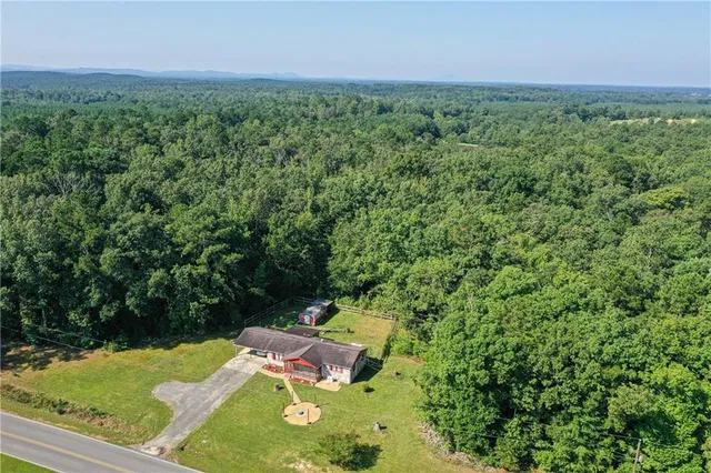 an aerial view of a house with a swimming pool
