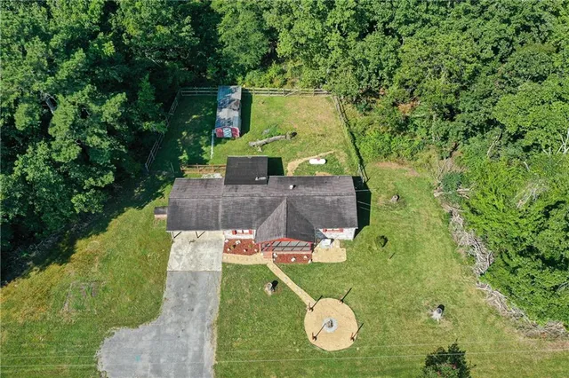 an aerial view of a house with a yard and lake view