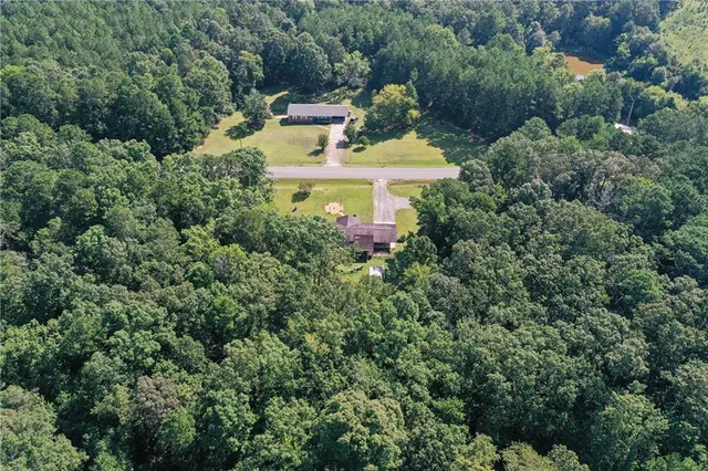an aerial view of a house a yard and lake view