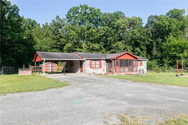 a front view of a house with a yard table and chairs