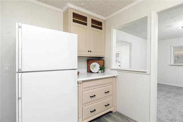 a white refrigerator freezer sitting inside of a kitchen
