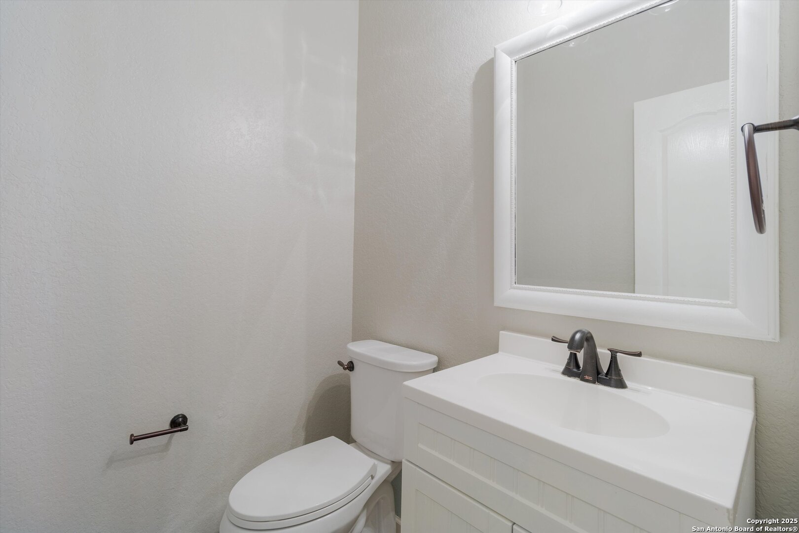 13506 Misty View San Antonio, TX 78245 - Photo 19 of 29 a white toilet sitting next to a bathroom sink