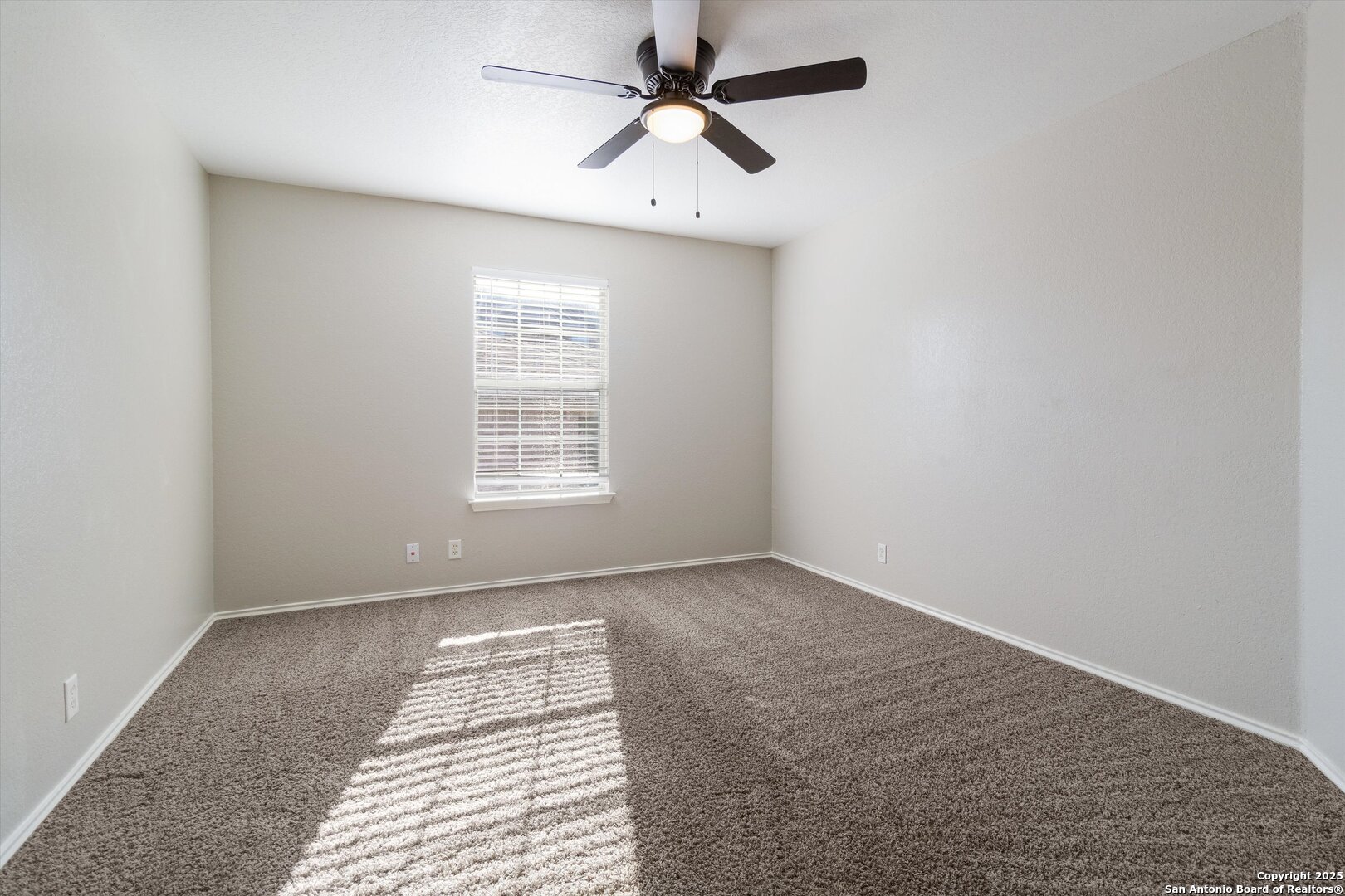 13506 Misty View San Antonio, TX 78245 - Photo 21 of 29 an empty room with windows and fan