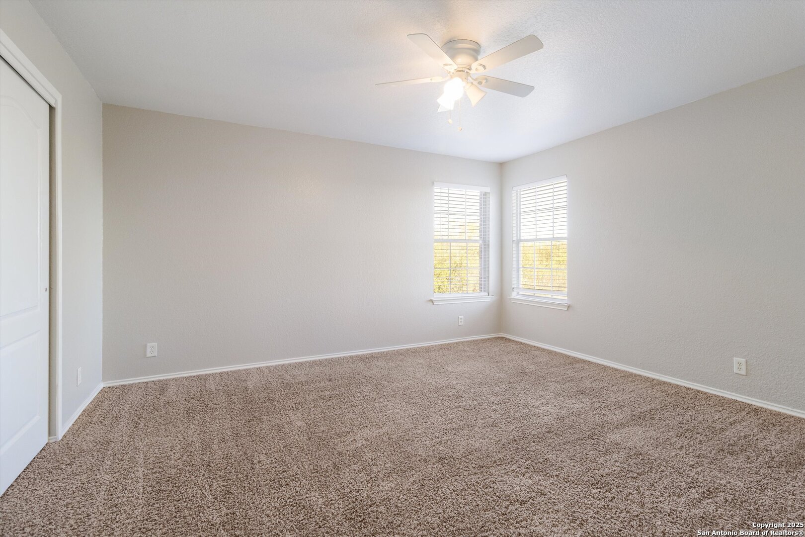 13506 Misty View San Antonio, TX 78245 - Photo 25 of 29 an empty room with windows and ceiling fan