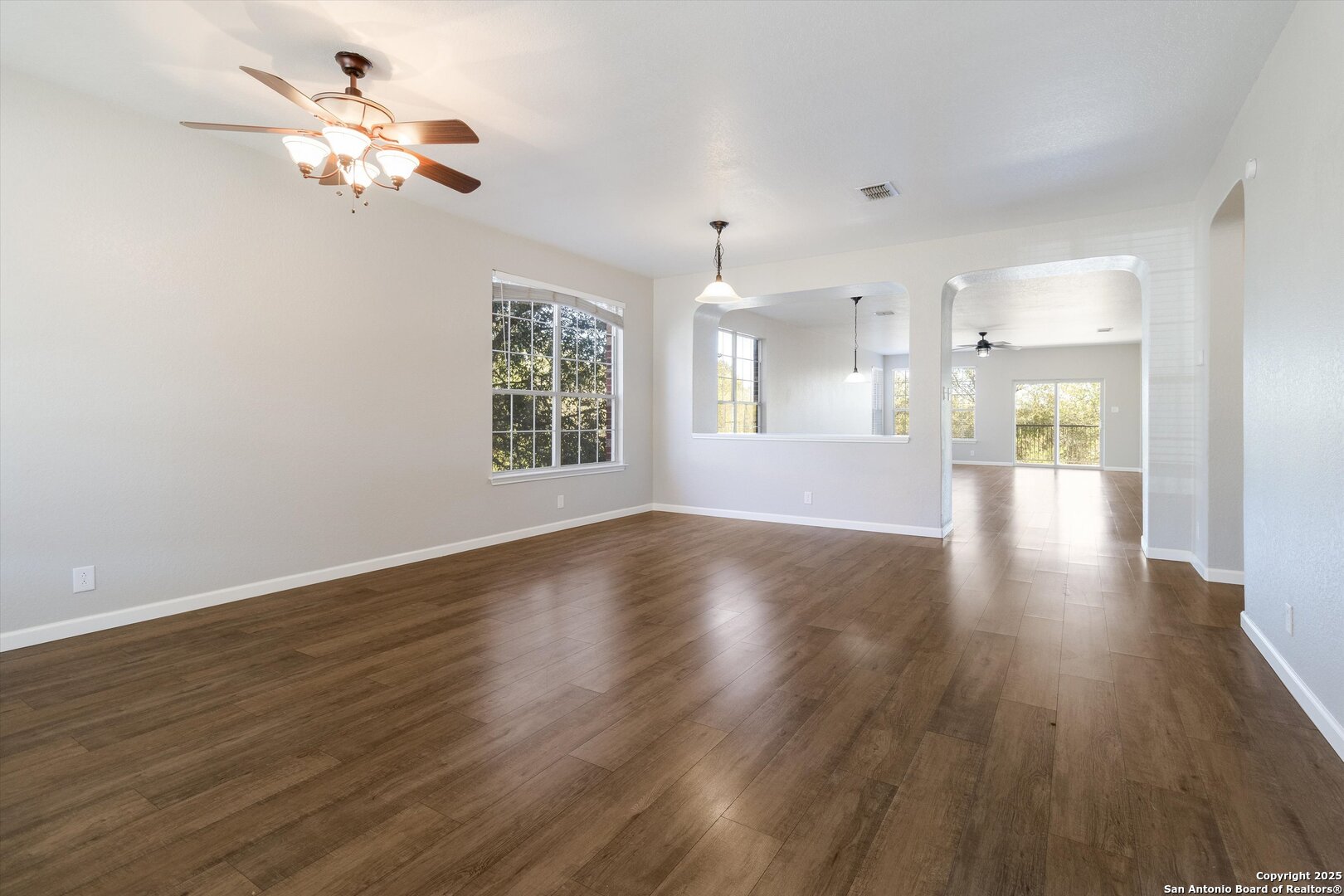13506 Misty View San Antonio, TX 78245 - Photo 5 of 29 a view of an empty room with a window and wooden floor