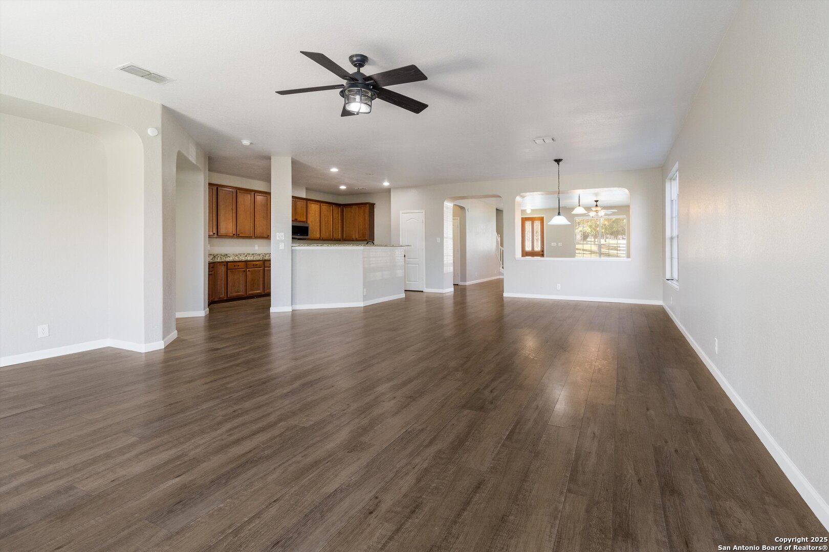 13506 Misty View San Antonio, TX 78245 - Photo 9 of 29 a view of an empty room with wooden floor and a window