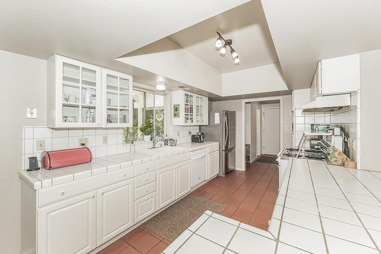 14815 Garlock Lane Prather, CA 93651 - Photo 16 of 80 a large white kitchen with cabinets