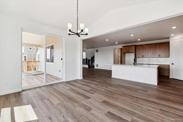 a view of a kitchen with a sink and wooden floor