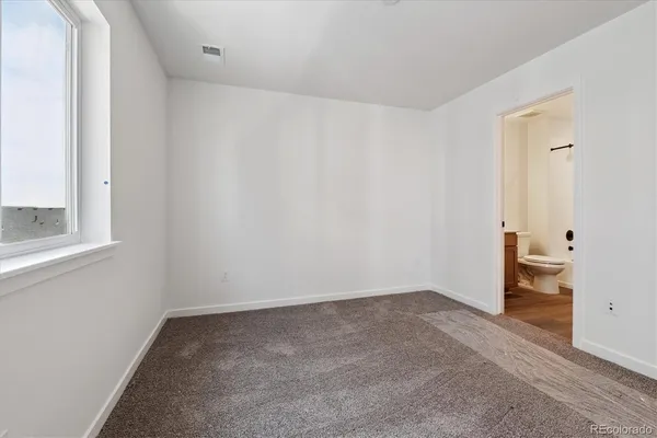 a bathroom with a sink a toilet a mirror and shower