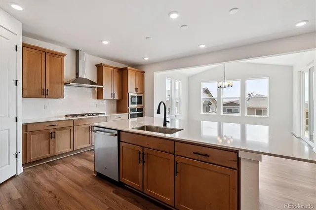 a kitchen with stainless steel appliances granite countertop a sink stove and cabinets