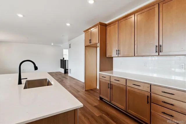 a kitchen with stainless steel appliances a refrigerator sink and cabinets