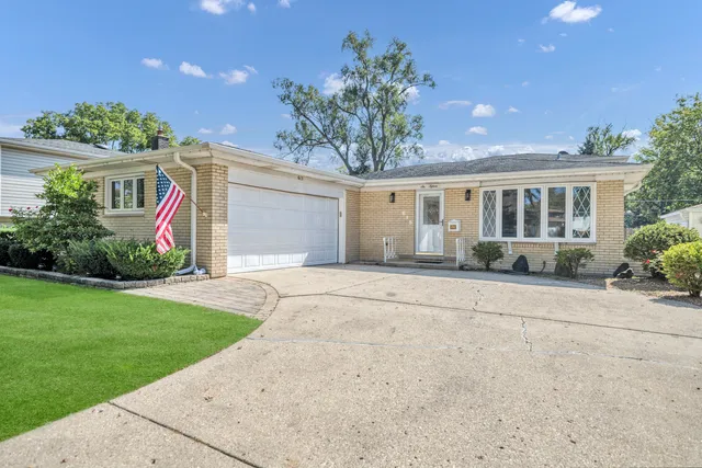 front view of house with a yard and potted plants