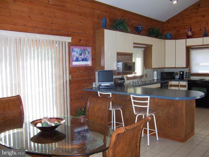 204 Burns Crossing Road Severn, MD 21144 - Photo 19 of 30 a kitchen with a table chairs and a window
