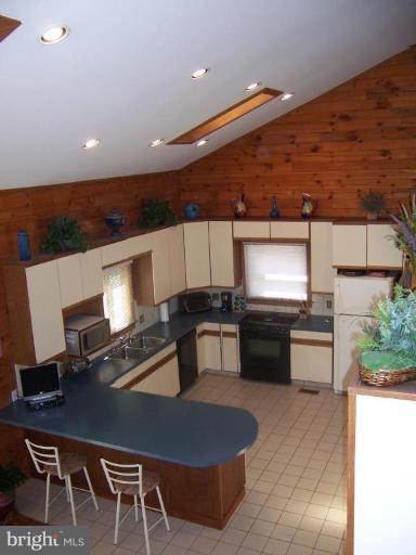 204 Burns Crossing Road Severn, MD 21144 - Photo 20 of 30 a kitchen with a table chairs and a stove