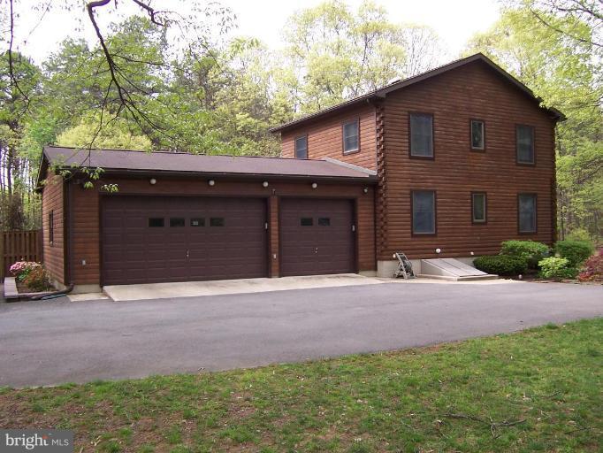 204 Burns Crossing Road Severn, MD 21144 - Photo 27 of 30 a front view of a house with a yard and garage
