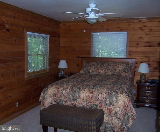204 Burns Crossing Road Severn, MD 21144 - Photo 7 of 30 a bed sitting in a bedroom next to a window