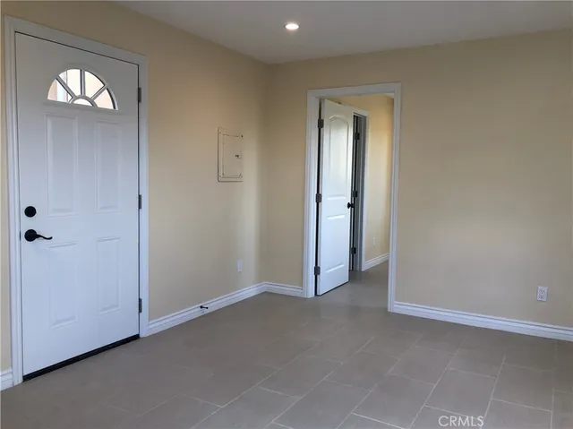 a view of a porch with furniture and floor to ceiling window