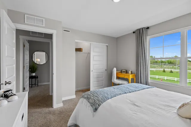 a bedroom with a bed and a dresser