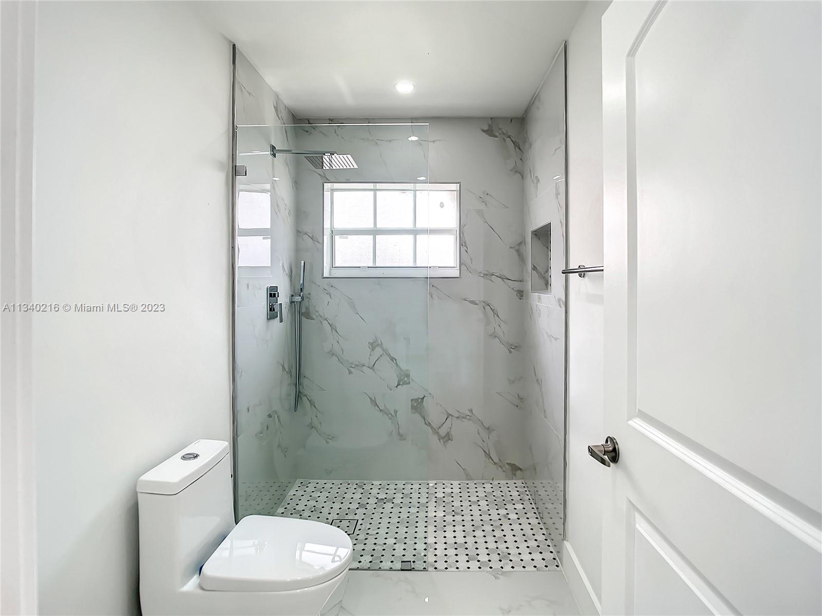 14031 Langley Place Davie, FL 33325 - Photo 13 of 27 a bathroom with a toilet and a shower