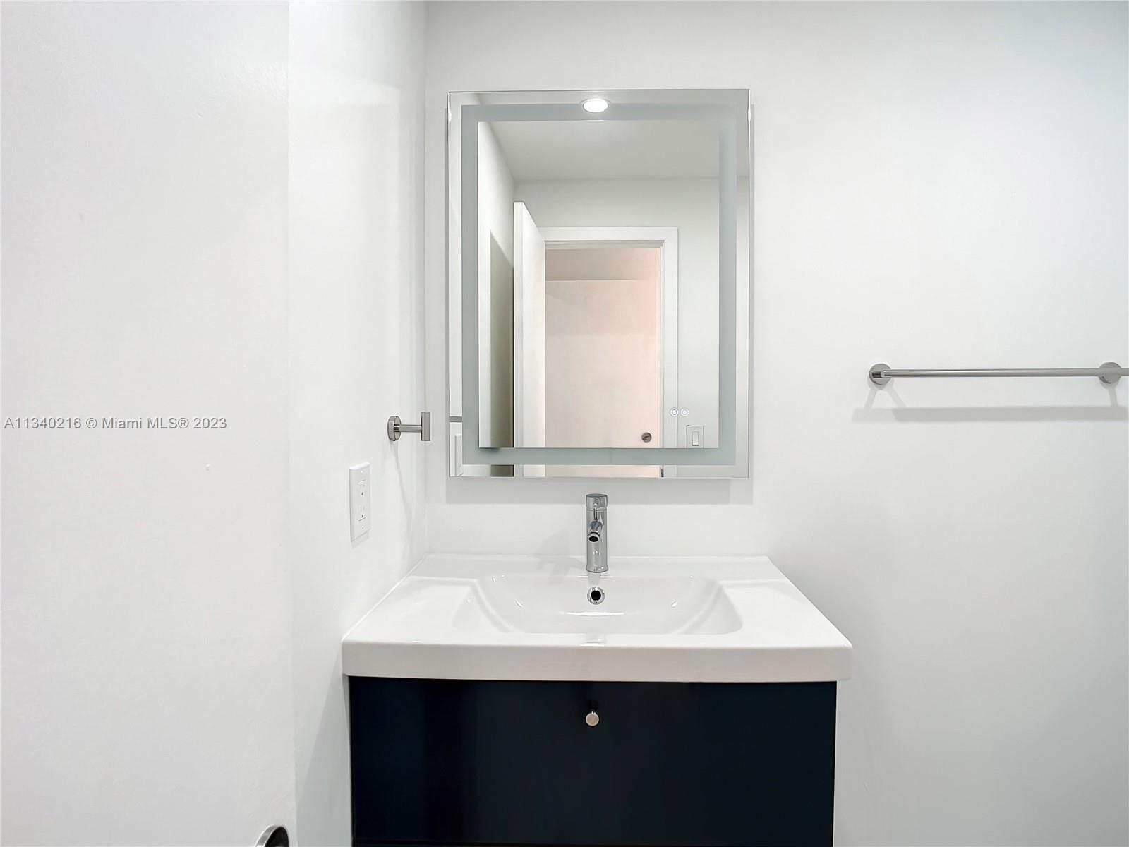 14031 Langley Place Davie, FL 33325 - Photo 15 of 27 a bathroom with a sink and a mirror