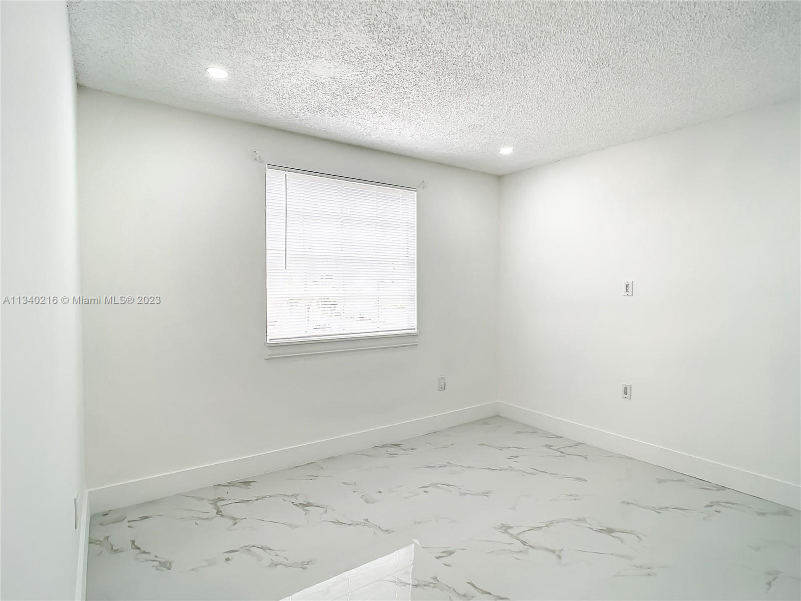 14031 Langley Place Davie, FL 33325 - Photo 17 of 27 an empty room with a window