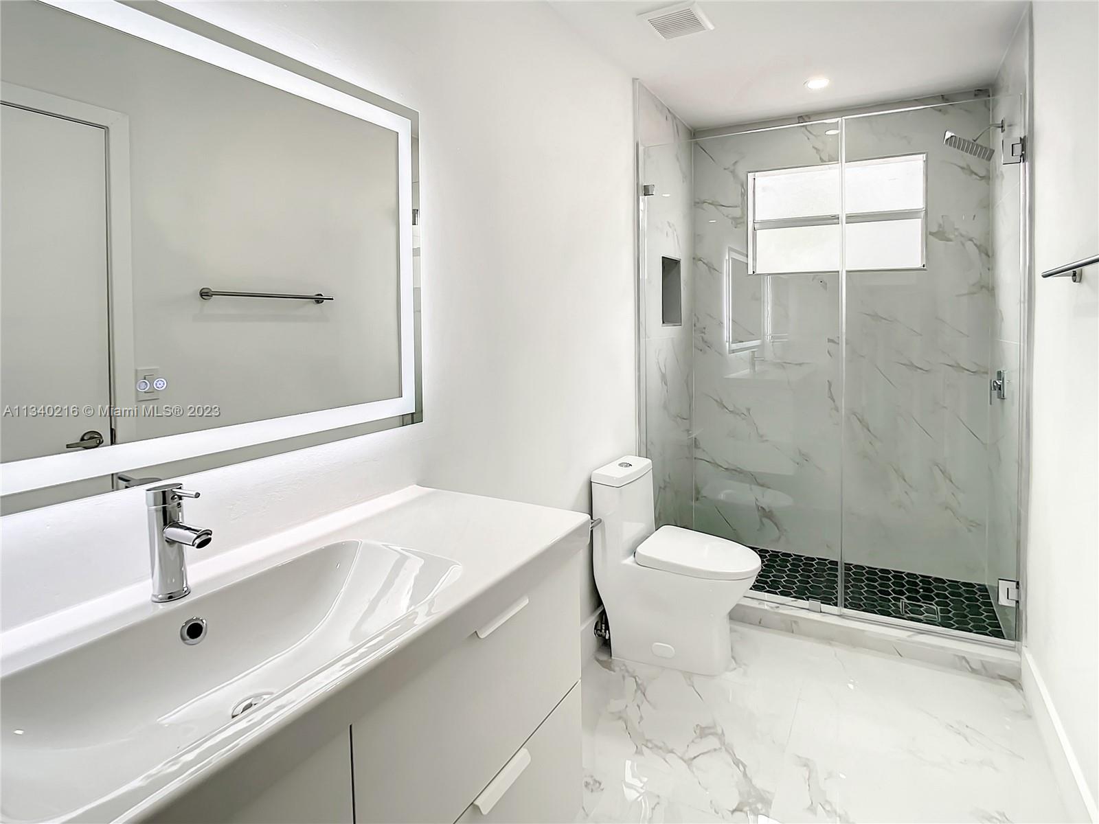 14031 Langley Place Davie, FL 33325 - Photo 20 of 27 a bathroom with a sink toilet and shower