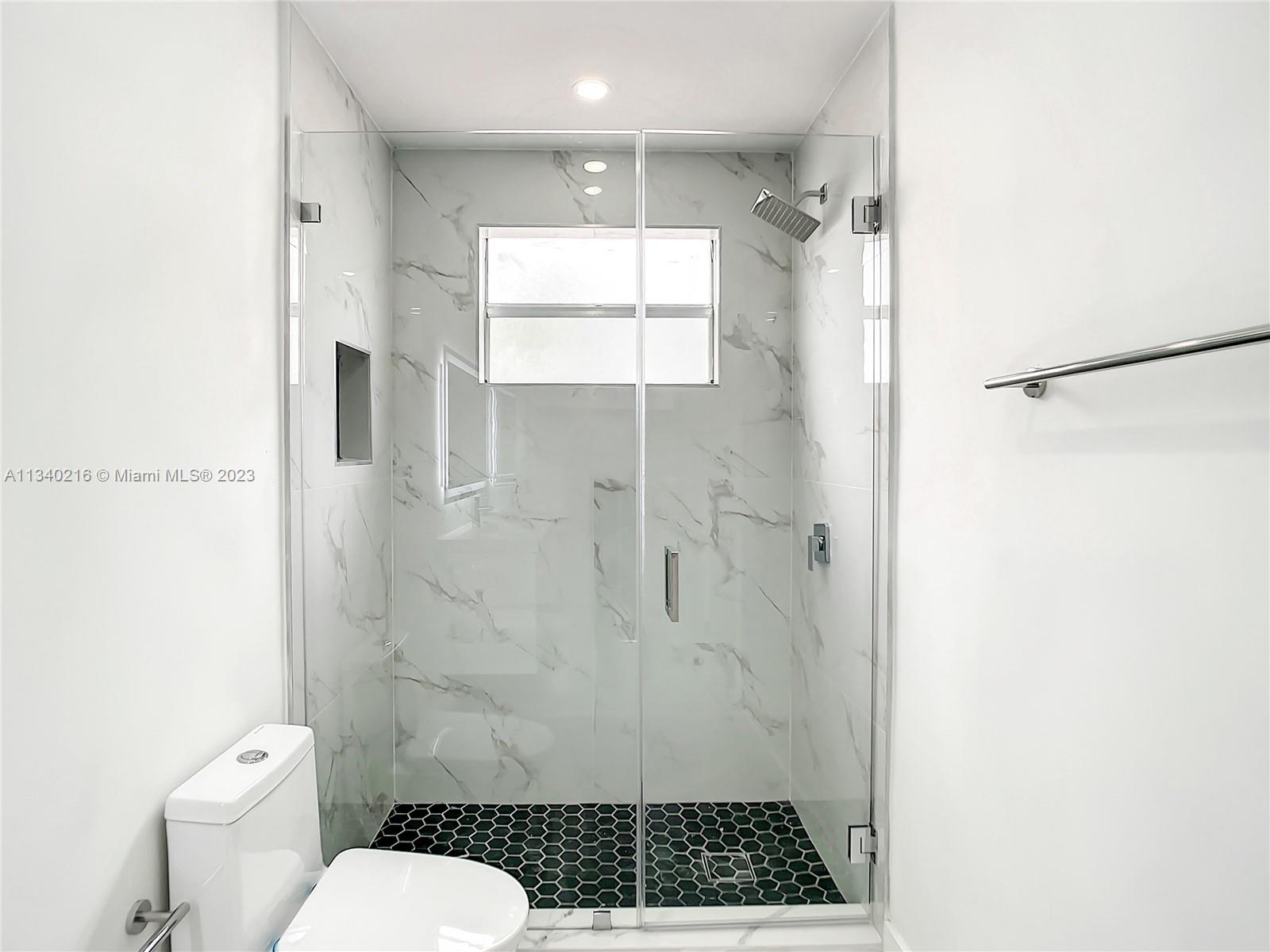 14031 Langley Place Davie, FL 33325 - Photo 21 of 27 a bathroom with a shower toilet and sink