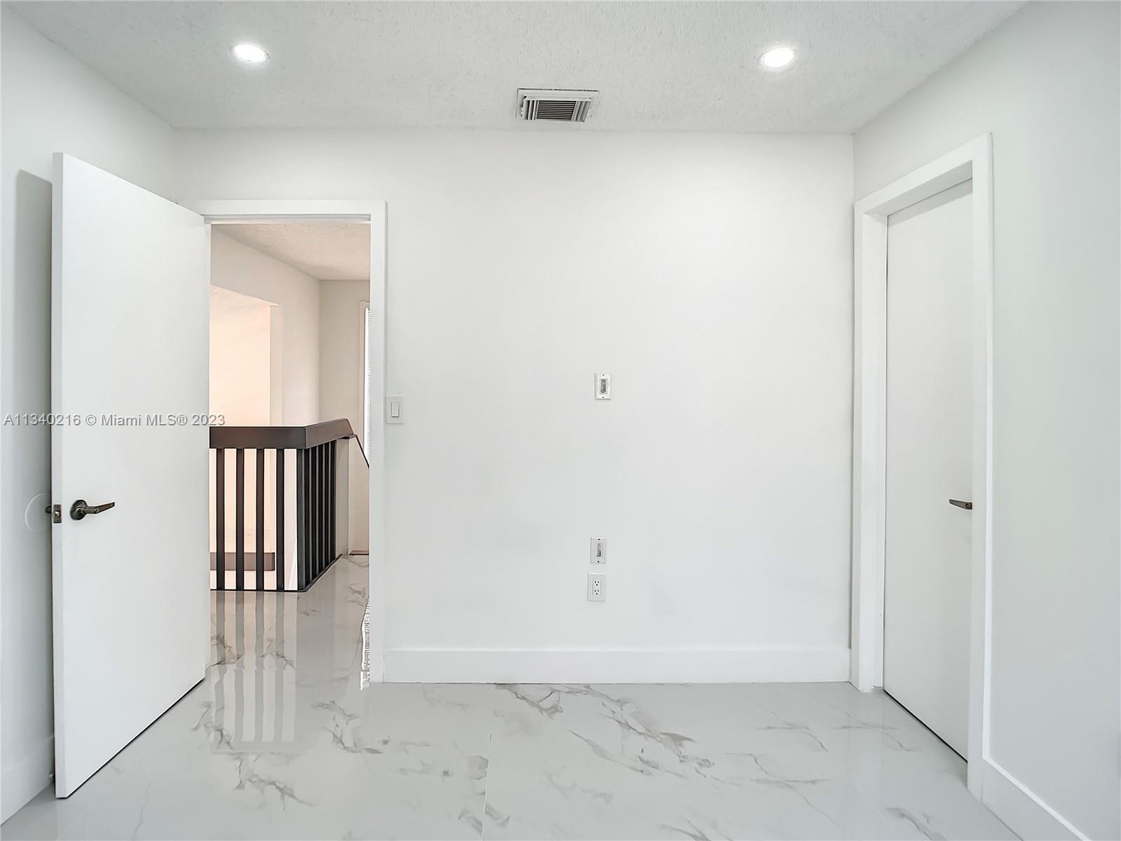 14031 Langley Place Davie, FL 33325 - Photo 22 of 27 an empty room with wooden floor