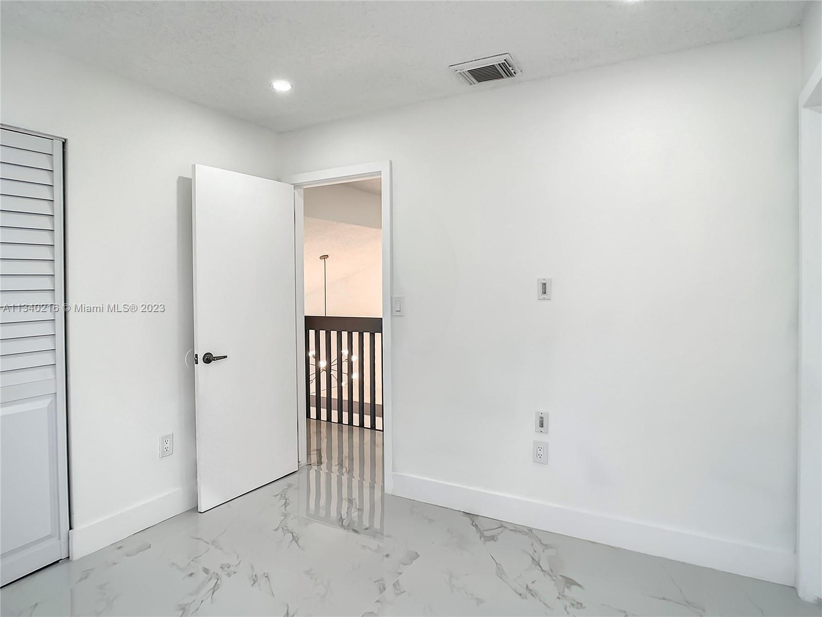 14031 Langley Place Davie, FL 33325 - Photo 24 of 27 a view of a hallway with a door in a room