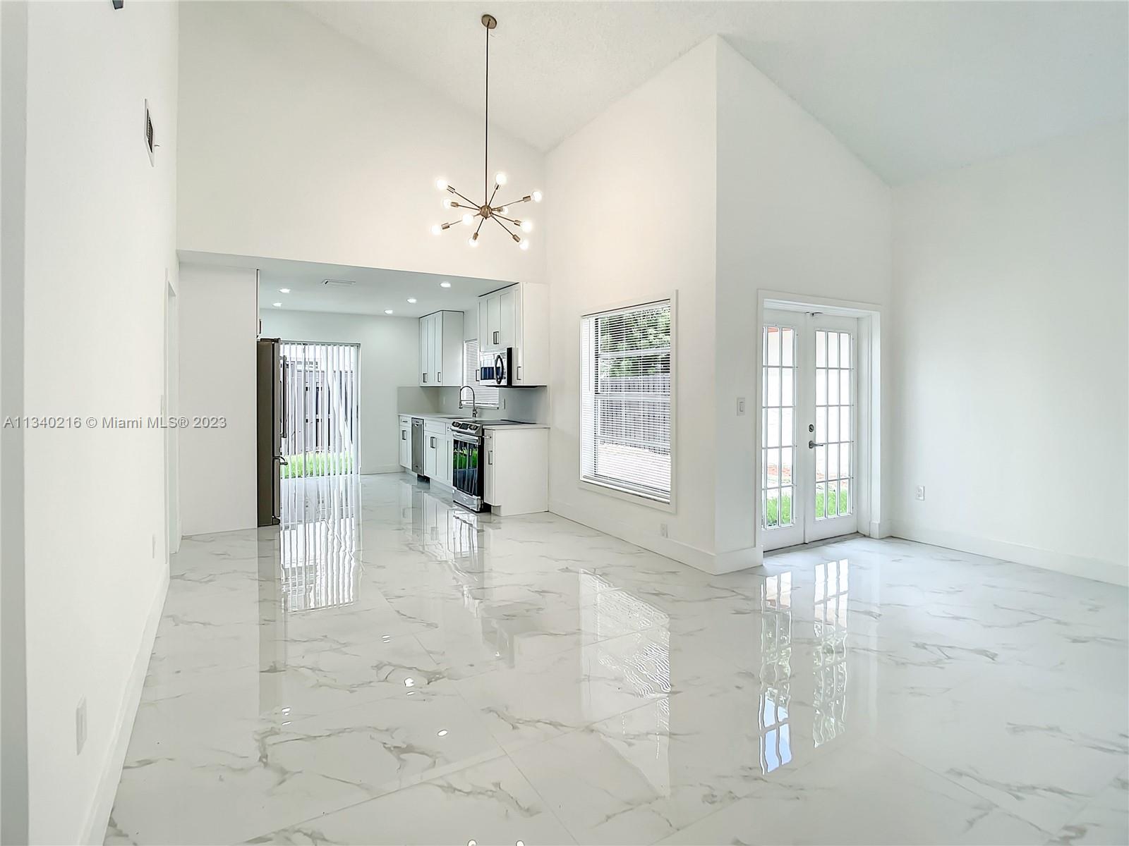 14031 Langley Place Davie, FL 33325 - Photo 7 of 27 a view of a kitchen with a sink and a chandelier
