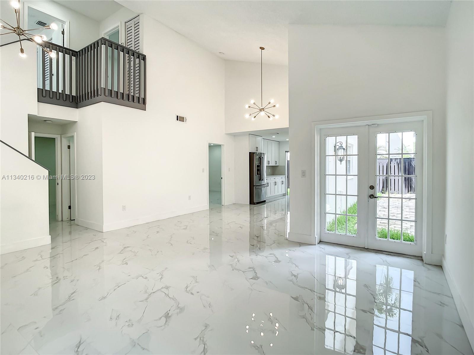 14031 Langley Place Davie, FL 33325 - Photo 8 of 27 a view of kitchen with granite countertop cabinets and refrigerator