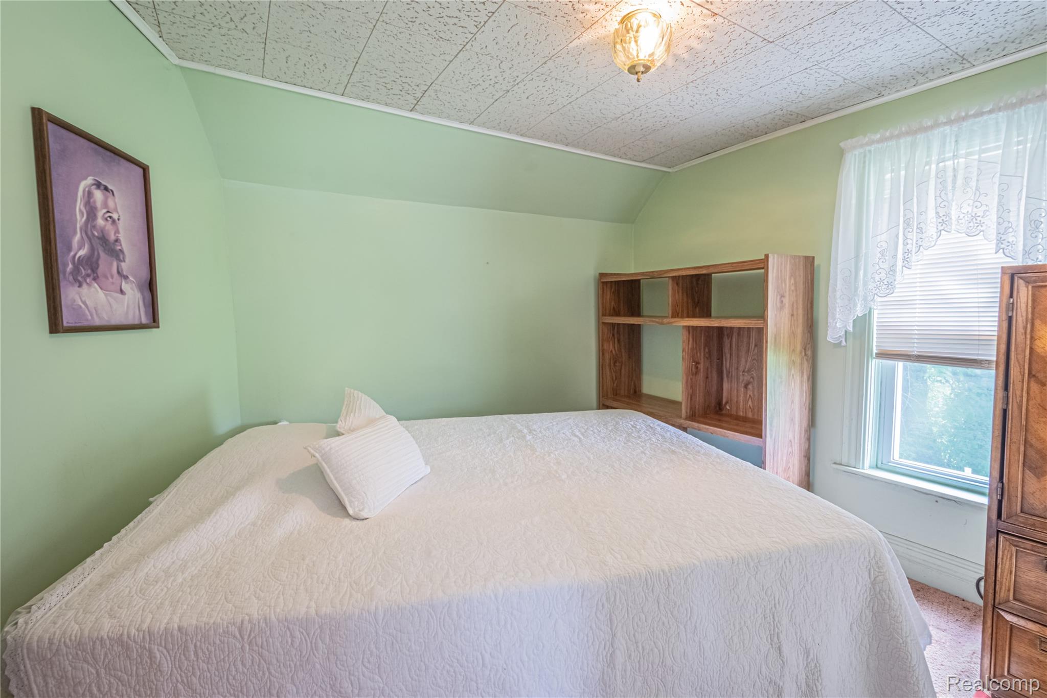 8384 Imlay City Road Avoca, MI 48006 - Photo 39 of 39 Room with angled ceiling, light green walls, and a textured ceiling