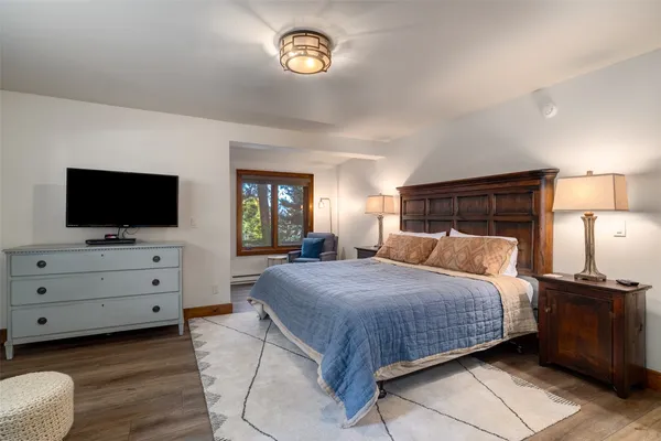 a bedroom with a bed and a flat screen tv