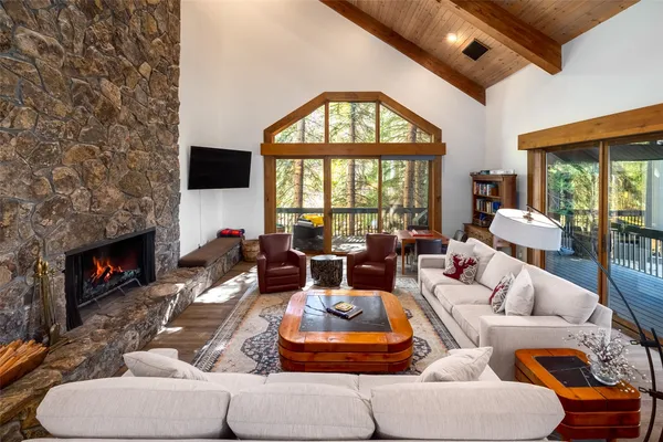 a living room with furniture a fireplace and a flat screen tv
