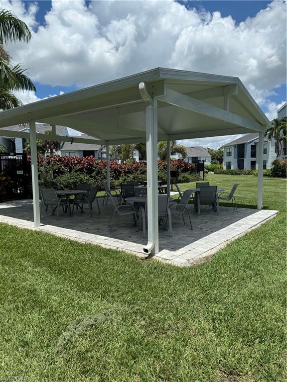 13631 Eagle Ridge Drive, Unit 226 Fort Myers, FL 33912 - Photo 17 of 19 a view of a chair and table in backyard of the house
