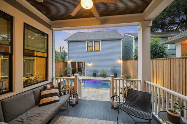 a view of a house with swimming pool and sitting area
