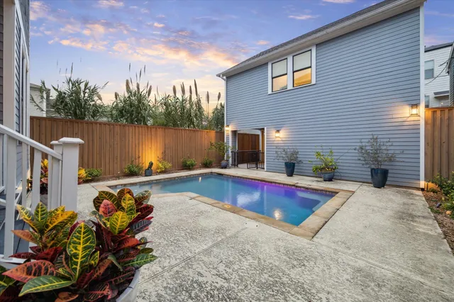 a view of a backyard with sitting area and lake view